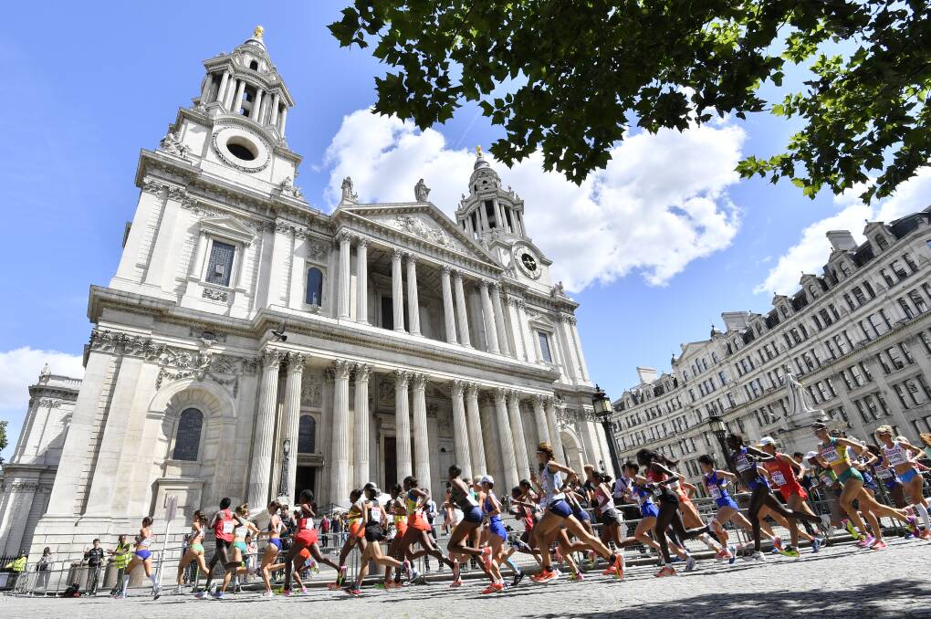 Devotion: Runners pass by St. Paul's Cathedral during the women's marathon at the athletics world championships in London on Sunday. Picture: AP 