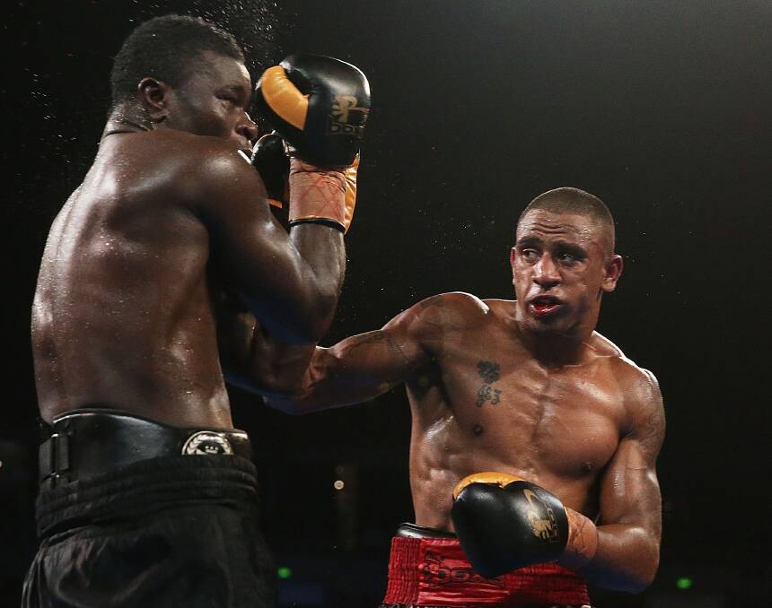 Big plans: Renold Quinlan (right) takes on Joseph Kwadjo in Sydney in 2013. Picture: Getty Images