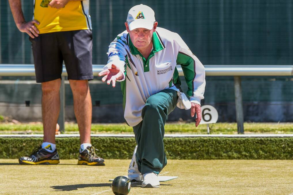 Green light: Scottsdale bowler Barry Dennis sends one down in his club's match at Longford. Picture: Phillip Biggs