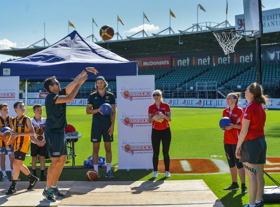 Target practice: Luke Hodge shows his basketball skills at the Hawks' gala day.