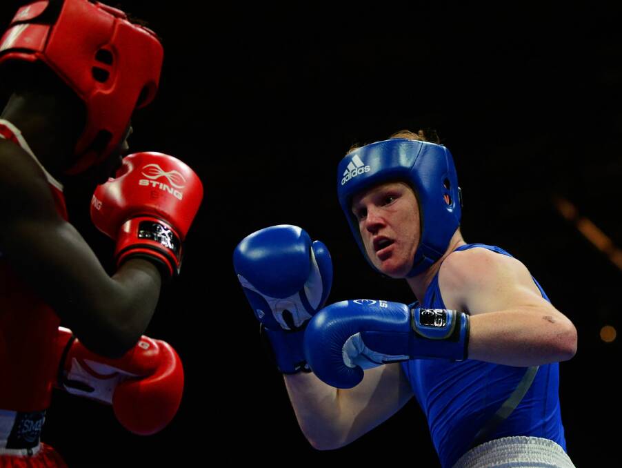 Eye line: Charles Joma (in red), of Victoria, takes on Travis Bruce, of the Grange Boxing Club, NSW, in a 69kg bout.