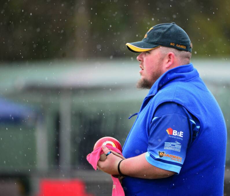 Take cover: Aaron Page, of Penguin, appears oblivious to Sunday's weather during the Bill Springer Invitational Singles held at the East Launceston Bowling and Community Club. Pictures: Phillip Biggs