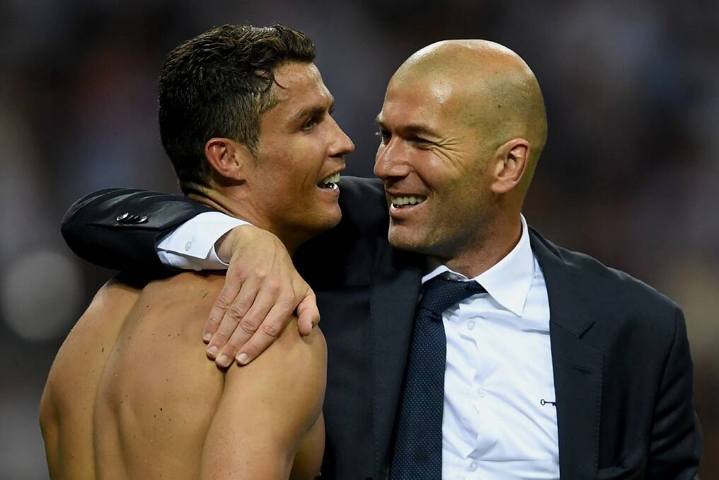 Gimme some skin: Zinedine Zidane congratulates Cristiano Ronaldo for getting his shirt in before the Real Madrid weekly laundry deadline. Picture: Getty Images