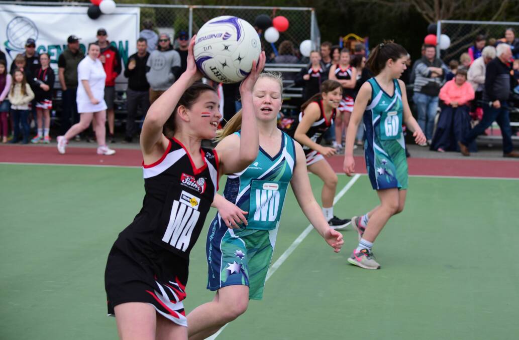 George Town Saints wing attack Olivia Walsh takes on Solar Generation wing defence Charlotte Roney.