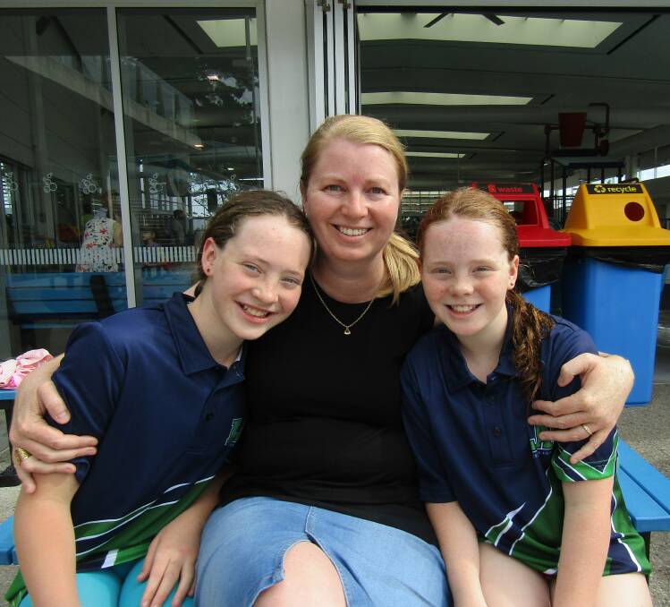 Golden girl: Emily Mitchell, 11, of Launceston, with her mother, Amanda, and sister, Grace, 9. Picture: Wendy Shaw