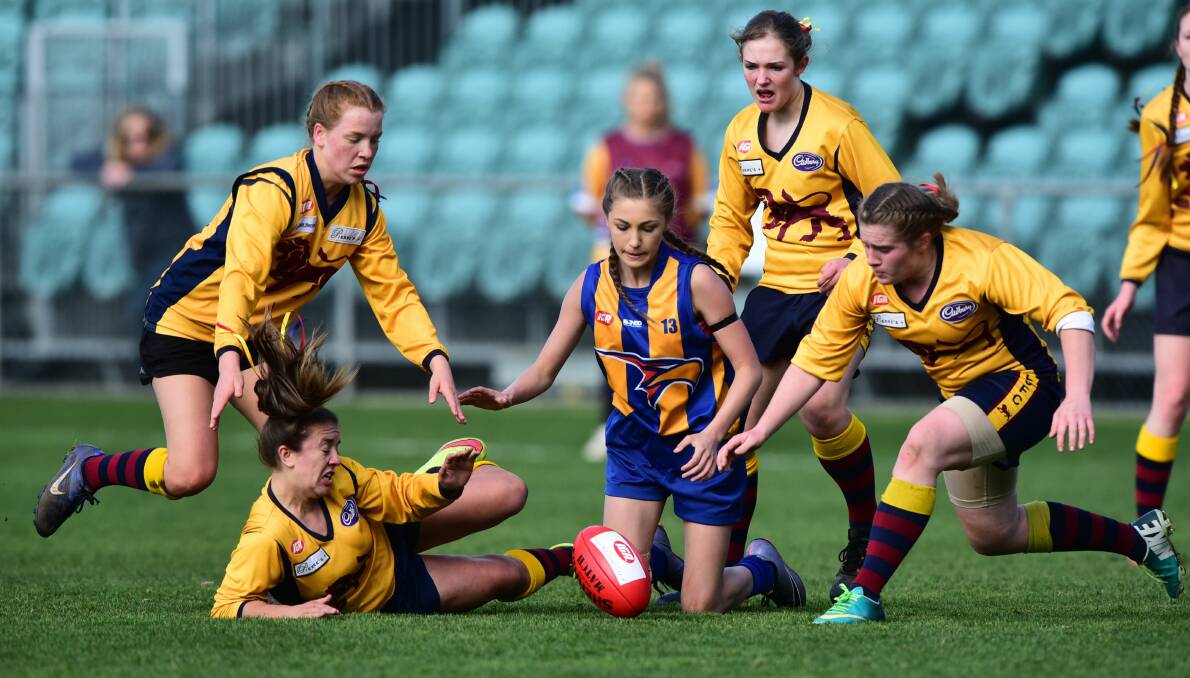 Evandale's Georgina Williams surrounded by East Launceston players.