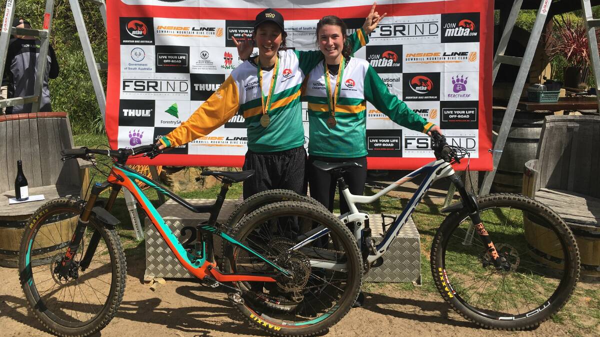 Down to earth: Australian enduro mountain bike champions Rowena Fry and Izzy Flint celebrate their victories at Fox Creek in Adelaide. Picture: Ben Mather.