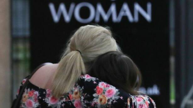 More images from the scene, hit the image above.
Ariana Grande concert attendees Karen Moore and her daughter Molly Steed, aged 14, from Derby, leave the Park Inn where they were given refuge. Picture: Getty Images
