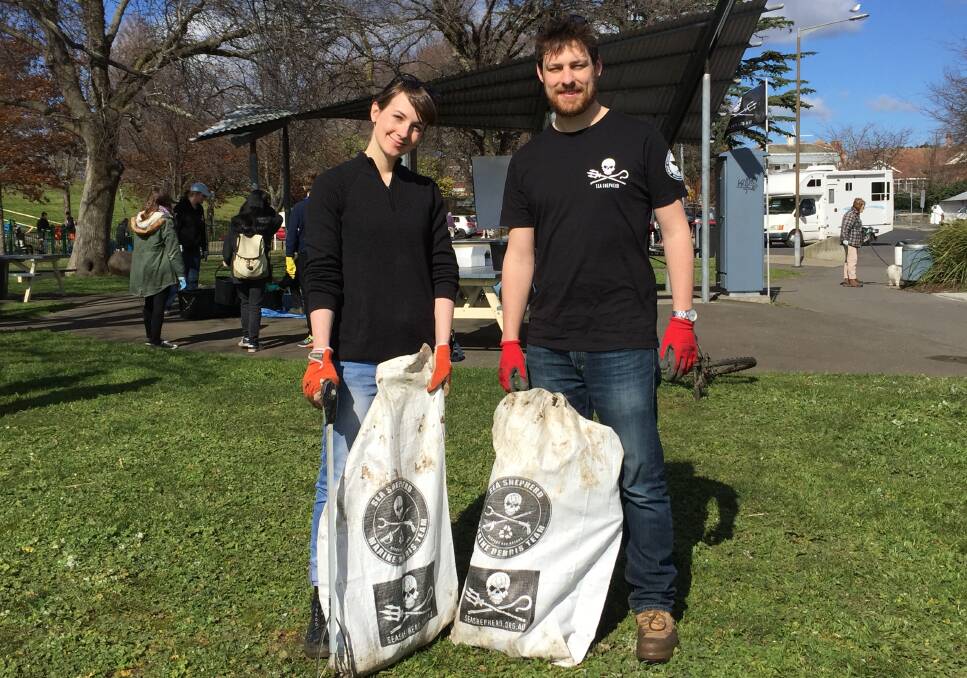 Volunteers Amy and Tom Dillon help collect debris from the banks of the Tamar River at Royal Park. Picture: Tarlia Jordan