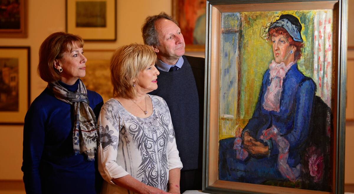 HISTORY: Louise Skabo, Carolyn Riley and Richard Mulvaney with a portrait of Edith Holmes by Dorothy Stoner. Picture: Phillip Biggs