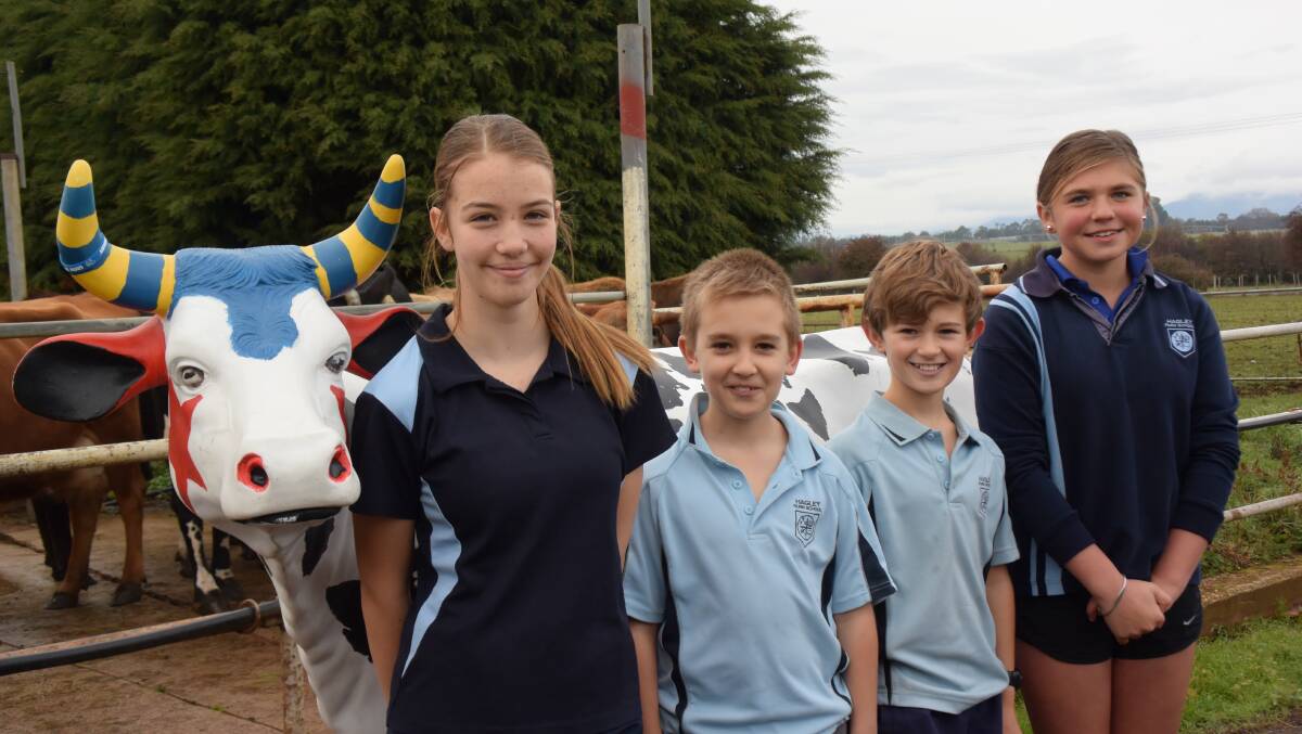 Niekaylah Binns, Jesse Eames, Daniel Douglas and Bella Dyer with their Picasso Cow they will paint over the next term at Hagley School Farm. Picture: Caitlin Jarvis