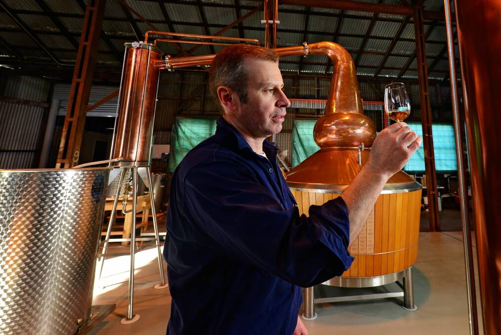 LIQUID GOLD: Launceston Distillery distiller Chris Condon with some of the product in the making. Distillery tours are available as part of this year's Whisky Week. Picture: Phillip Biggs.
