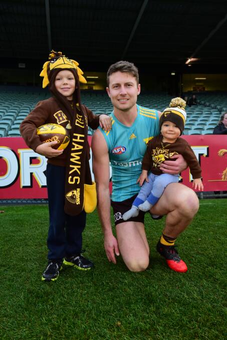 GAME ON: Liam Shiels with Harrison Beecroft, aged six, and his little brother Archer Beecroft, nine months, of Launceston, at the Hawks' training session on Friday. Picture: Paul Scambler
