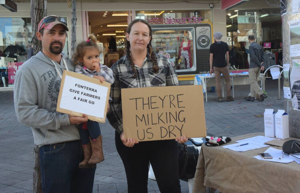 PRESSURE: Third-generation dairy farmer Byron Carins and his wife Danielle in the Launceston Mall protesting against the shock cuts to the global dairy price made by Murray Golbourn and Fonterra last week. Picture: Caitlin Jarvis.