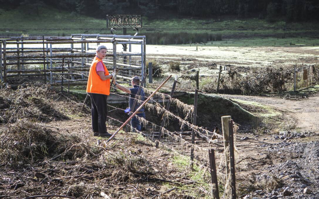 CLEAN UP HELP: Volunteers from charity organisation Blazeaid help to clear debris from a rural property at Gunns Plains. The state and federal governments have announced funding grants to assist with the removal of debris from rural properties after the June floods. Picture: Cordell Richardson.