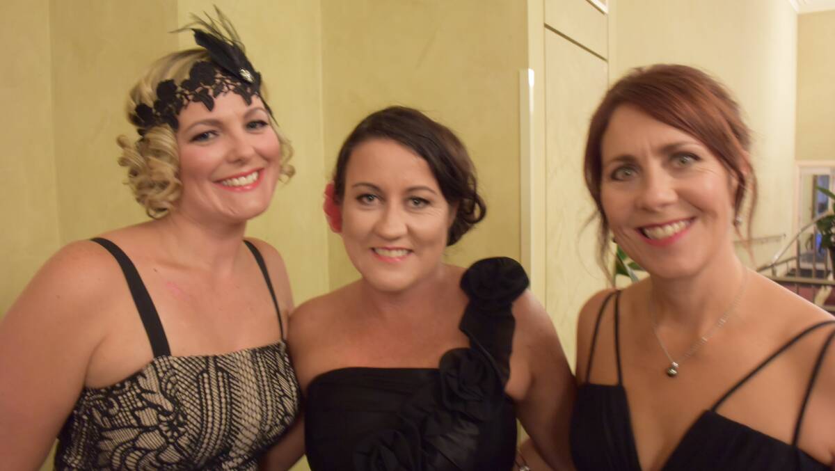 In the spirit of the evening are Kim Alford and Sally Rigby, both of Launceston, with Lynne Cipura, of West Launceston.