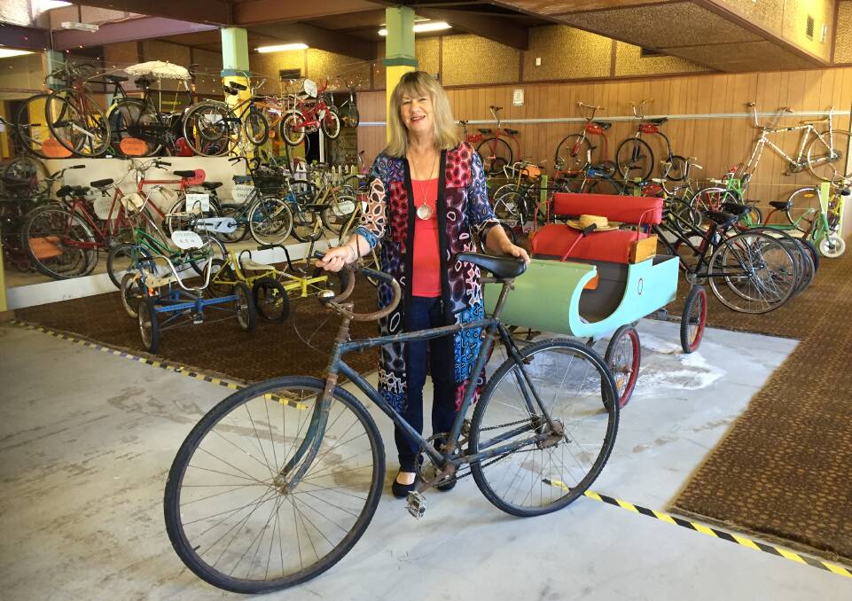 Wheeled wonders: Pastor Merilyn Billing with the "Bitza" from her late father Graham Austin's bicycle collection, which will open to the public during Bike Week.