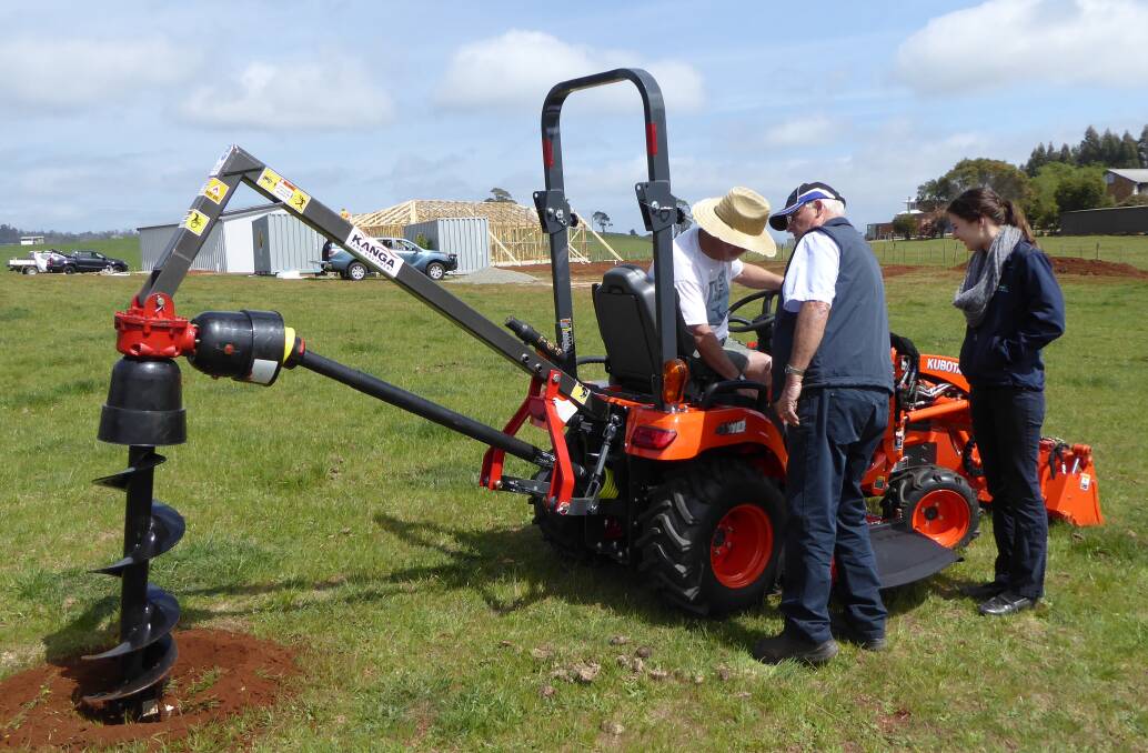 SUPER SERVICE: Tasmania Farm Equipment's Amy Dyer and John Wilson showed new Kubota owner Brett Gower how to operate the machine and its accessories.