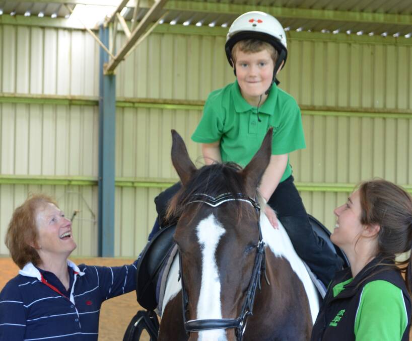 Eliott Bartninkatis has a great time riding supervised by volunteer Phyllis Pyke and Danielle Whatley of Giant Steps.