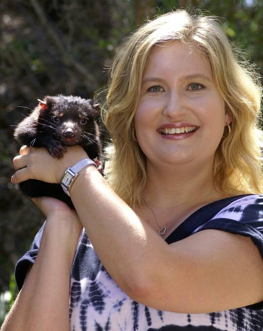 DISCOVERY: Geneticist Kathy Belov with a devil pup. Picture: Sydney University
