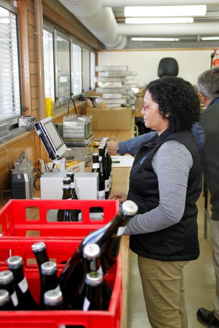 BUBBLING TECHNOLOGY: PhD student Gail Gnoinski uses an in-bottle scanning device that enables researchers to analyse the sparkling wines objectively without opening them. Picture: Supplied