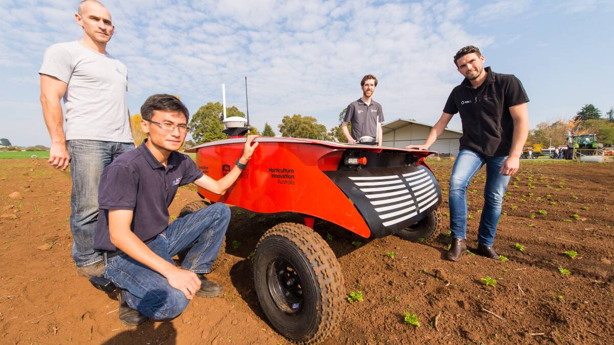 FUTURE FARMING: Engineer Vsevolod Vlaskine, research fellow Zhe Xu, engineer Justin Clarke and science communication consultant Carl Larsen with RIPPA, an example of farming innovation. Picture: Phillip Biggs