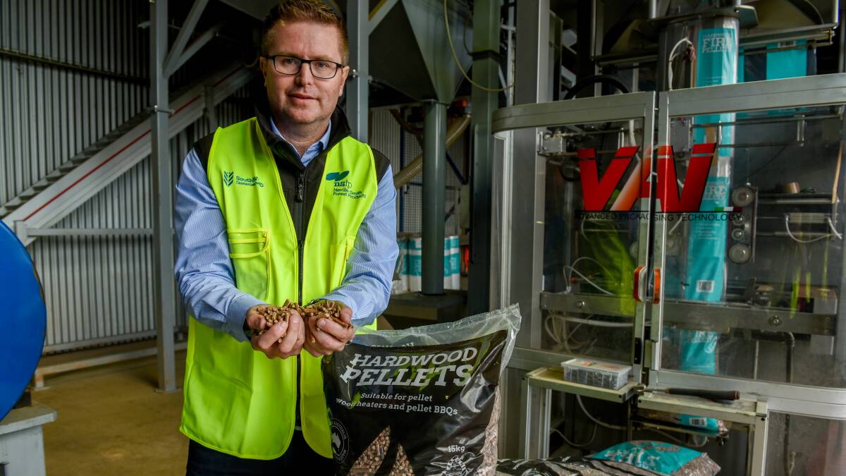 VALUE ADDING: Neville-Smith Forest Products chief executive Andrew Walker with wood pellets produced at Mowbray. Picture: Paul Scambler