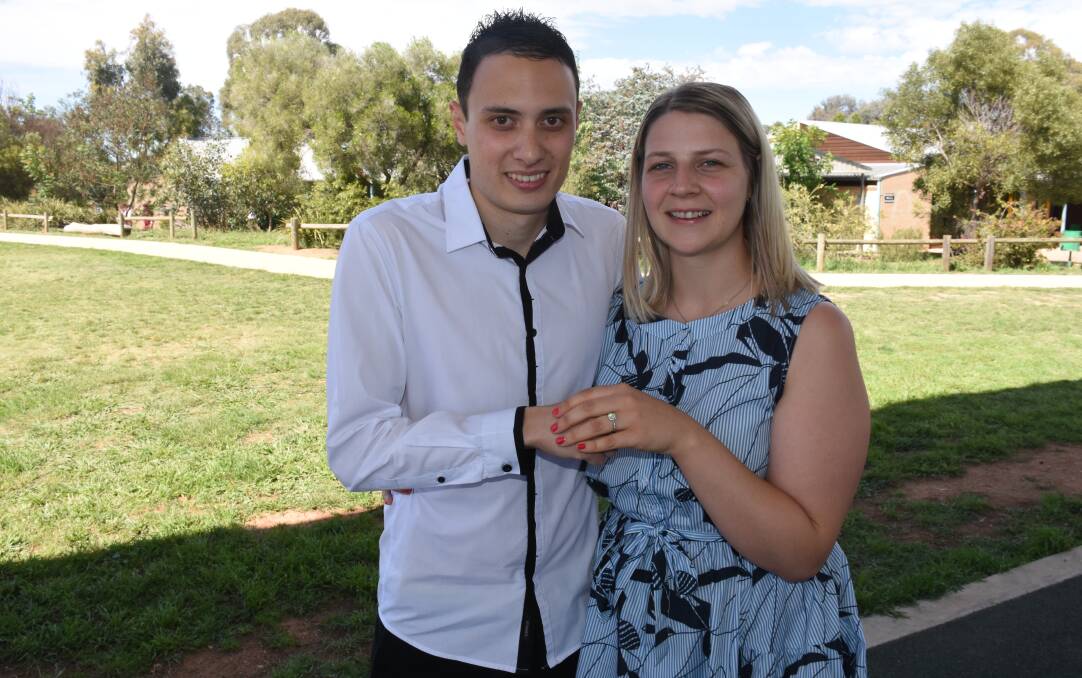 SHE SAID YES: Ben Mann and Aimee Garland after his proposal in front of the school. Photo: NADINE MORTON 120817nmyes28