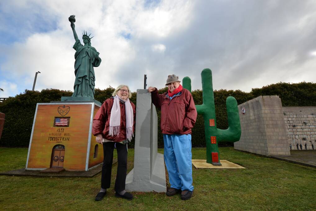 READY TO GO: Owners of Tasmazia & The Village Of Lower Crackpot, Brian and Laura Inder show off the new attraction, a wall separating the US and Mexican embassies. Picture: Brodie Weeding