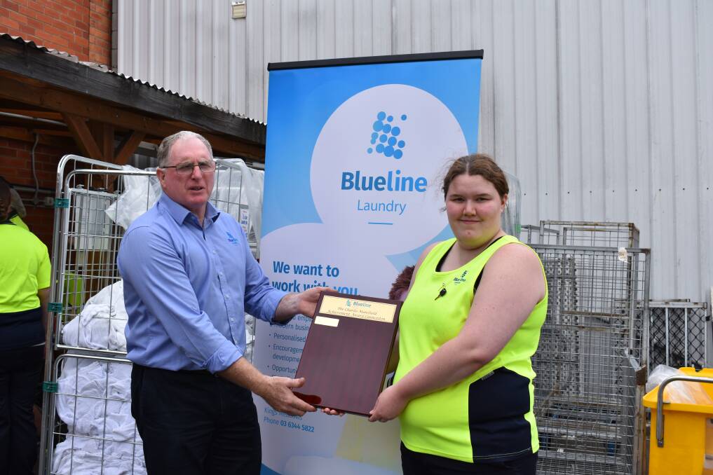 THANKFUL: Grant Coker-Williams awarded Blueline Laundry's first achievement award to Rebecca Kerrison and Joshua Reid on Wednesday.
