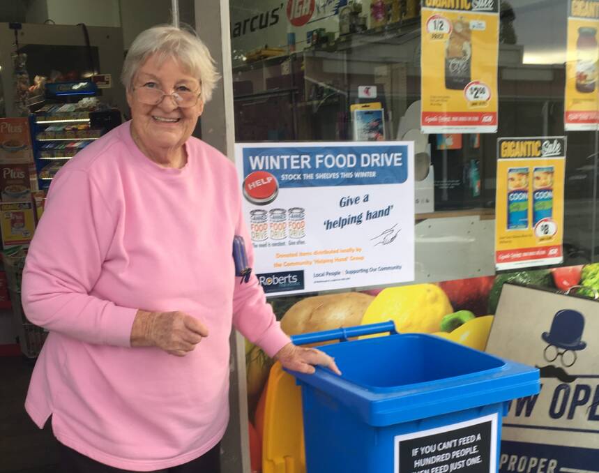 DONATE: Elise Wrigley was the first person to donate a non-perishable food item to Roberts Real Estate's food drive. Picture: supplied.