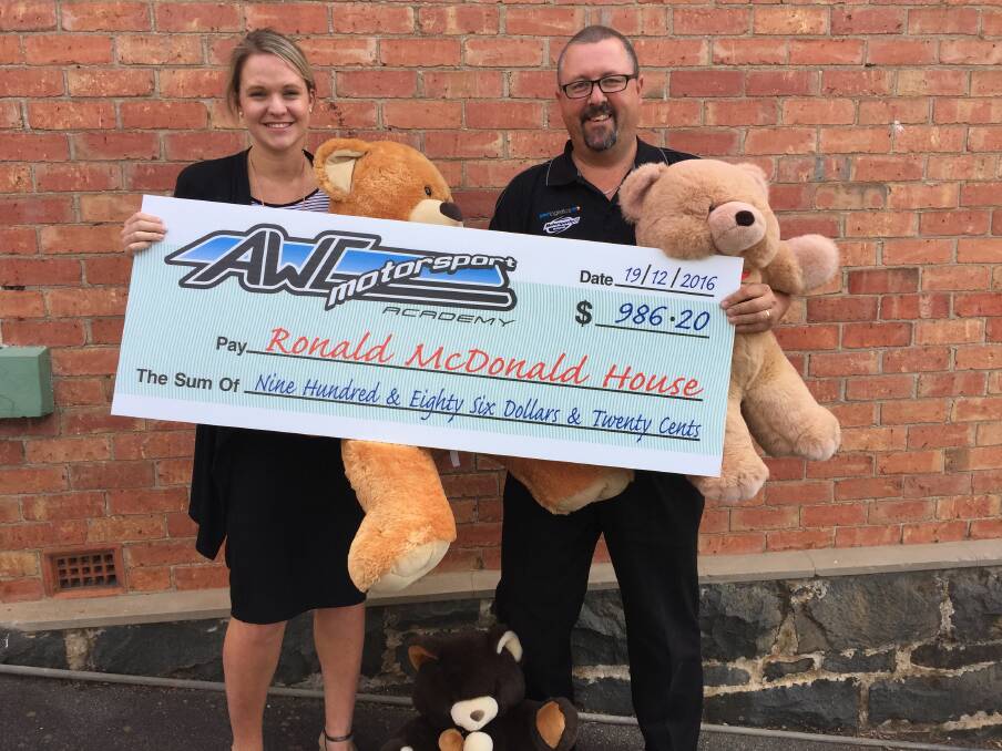 GIVING: McDonalds marketing manager for the North Sarah Green accepts the cheque from AWC Motorsport Academy promotions officer Stuart Lee. Picture: Tarlia Jordan 