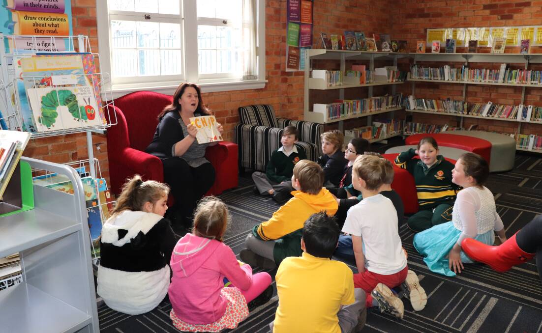 LISTENING: Our Lady of Mercy students were treated to a number of guest readers, including drama and theatre professor Liz Bennett during Book Week. Picture: supplied.