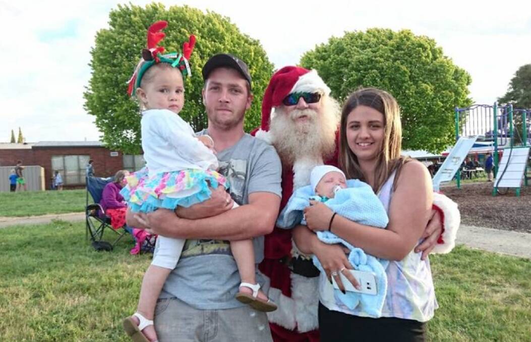 CHEER: Miah, Jayden and Levi Bennett and Jessica Maynard with Santa at Ravenswood Presents Carols in the Evening. Picture: supplied.