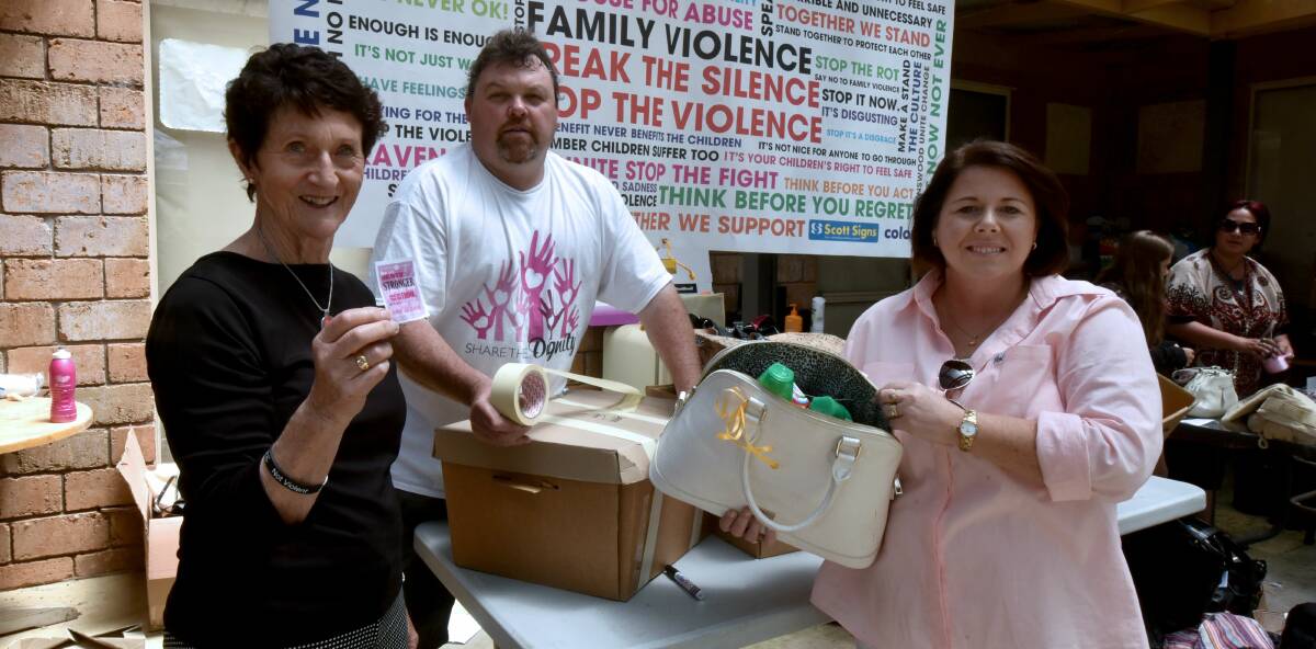 SHARING KINDNESS: Colleen Breheney with Scott and Tania Ranson filling the handbags for domestic violence victims. Picture: Neil Richarson.