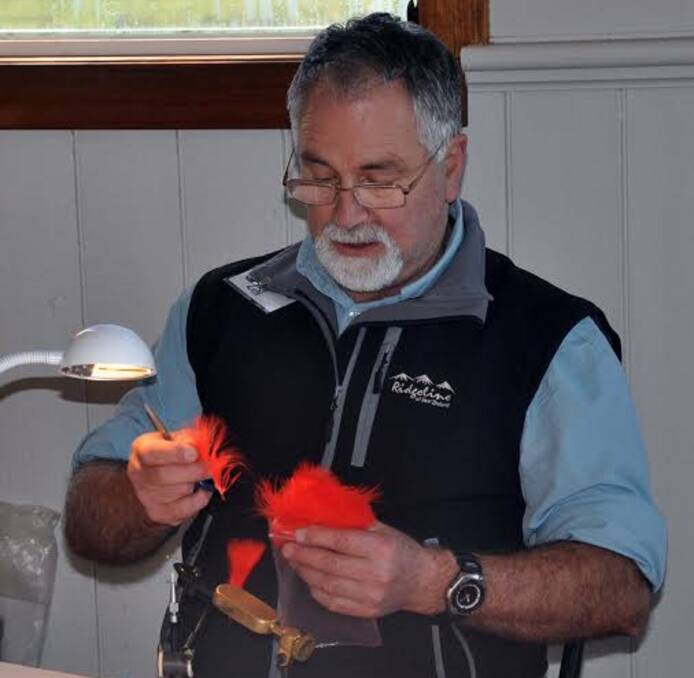 ALLURED: Trevor Berne inspects a lure at a previous Quamby Fly Fishers Club open day. This year's event is being held on July 23 at Meander Hall. Entry is a gold coin donation. Picture: supplied.