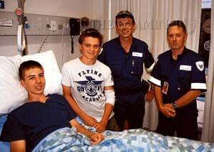Henry Strong with Julian Woods and paramedics Daniel Kotynia and Jon Purtell at the Launceston General Hospital yesterday. Both youths are recovering after falling at the Cataract Gorge.
