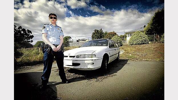 Acting Sergeant Sandy McDougall with the Holden Commodore station wagon that was seized by police.  Picture: SCOTT GELSTON