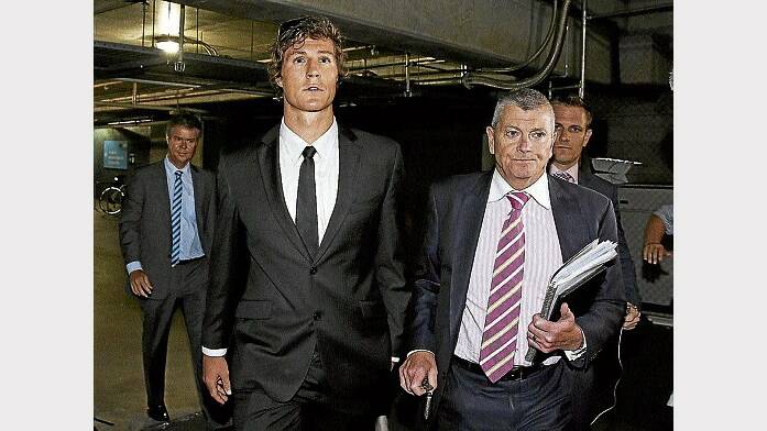 Former Adelaide footballer Kurt Tippett walks out with David Galbally, QC, after the Crows' AFL Commission hearing at AFL House in Melbourne on Friday. Picture: GETTY IMAGES