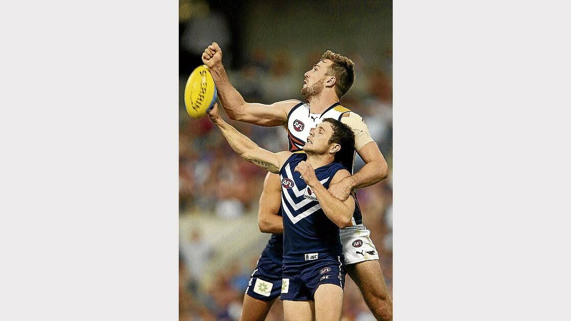 Eric Mackenzie, of West Coast, spoils the mark for Hayden Ballantyne, of Fremantle, during the round 1 match on Saturday.