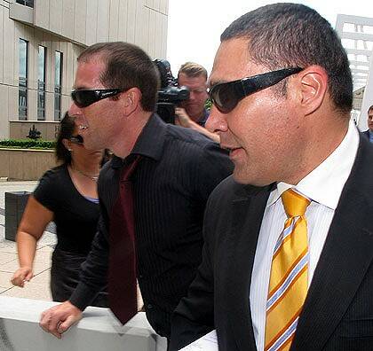 Alleged spammer Lance Atkinson (left) and his lawyer Darrell Kake (right) leave the Federal Court in Brisbane. Photo: Scott Casey