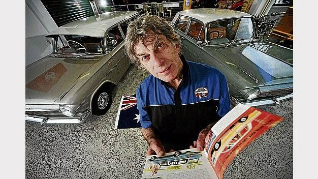 National Automobile Museum employee Phillip Dean looks over a manual for the EH Holden. Picture: PHILLIP BIGGS