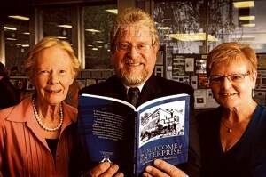 Author Julian Burgess displays his new book, flanked by Friends of the Library Barbara Valentine and Jennifer Lyons.  Picture: PHILLIP BIGGS