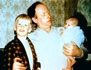 Martin Bryant, already a troubled child, poses while his father Maurice holds newborn daughter Lindy. (1/2)