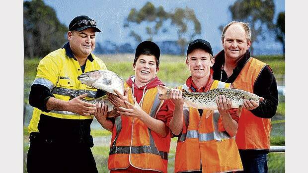 Petuna Seafoods hatchery manager Shaun Slevec, Cressy District High School grade 8 students Mathew Hayward and Xavier Cherdron and Tasmanian Trout Expo president Richard Goss wrangle a couple of slippery catches.