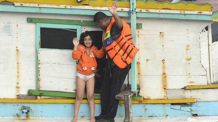 Officers on a boat that had been missing offload people at Christmas Island. Photo: Sharon Tisdale