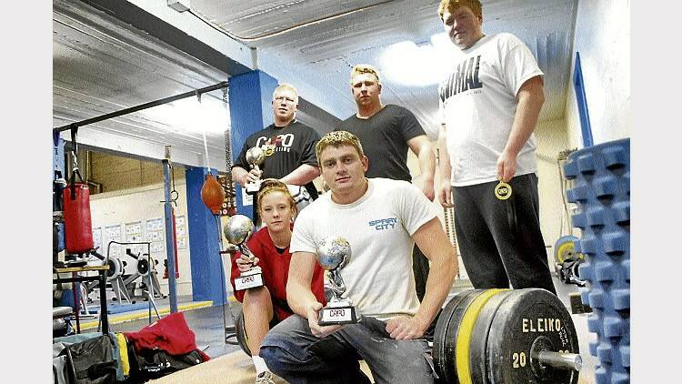 PCYC powerlifters Luke Mayne, Jacob Oakenfull, Ryan Oakenfull, Johnny Riley and Tiarna Davis show off the medals and trophies they won at the national championships, held in Hobart last weekend. Picture: COREY MARTIN