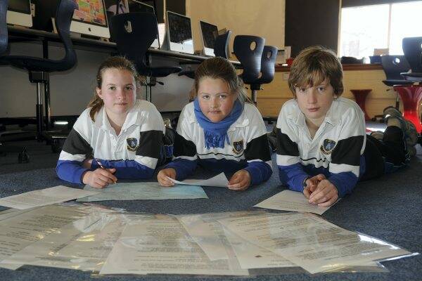 Launceston Church Grammar School pupils Morgan Wye, 11, Lara Baker, 10, and Jaan Schild, 11, during yesterday's Write A Book In A Day challenge.  Picture: PAUL SCAMBLER