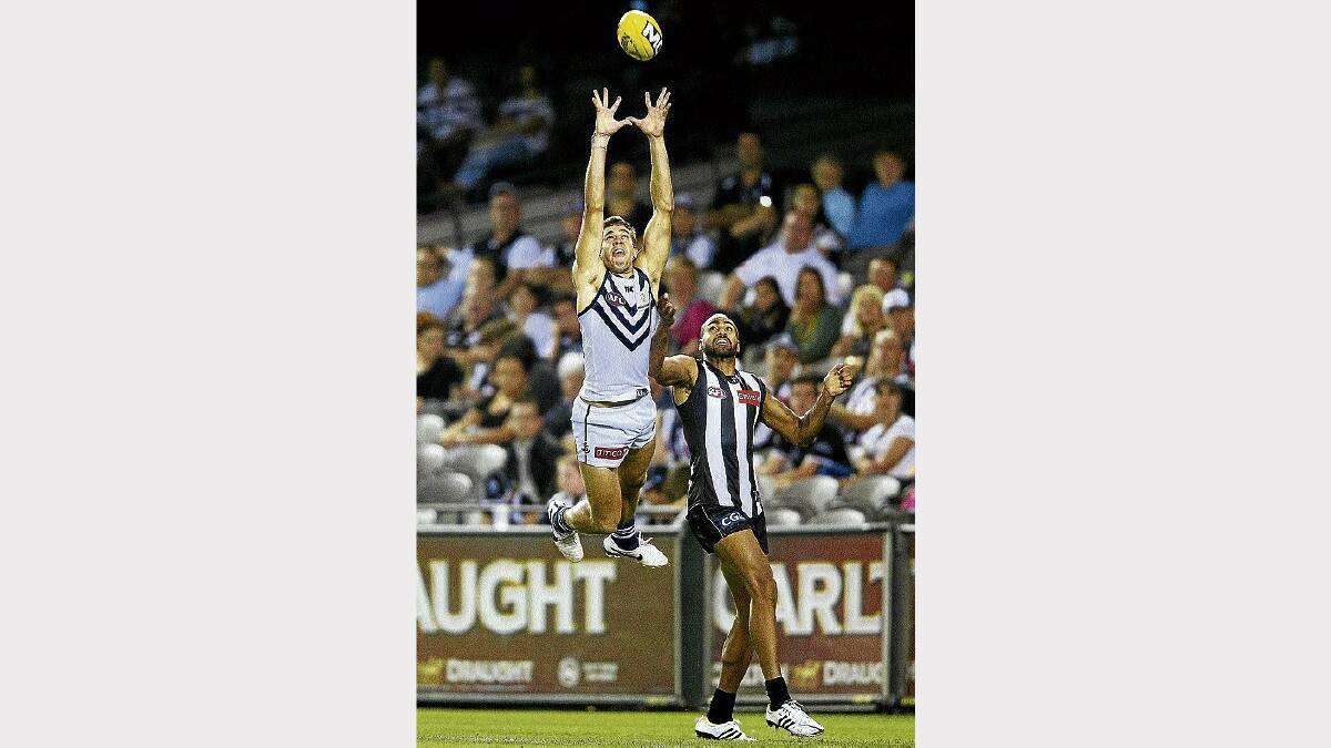 Fremantle's Stephen Hill leaps and marks in front of Collingwood's Heritier Lumumba in last night's opening round clash at Etihad Stadium. Picture: GETTY IMAGES