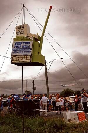 Anti-pulp mill protesters outside the Gunns annual meeting "drop the mill" using a model on a pole. Picture: PHILLIP BIGGS